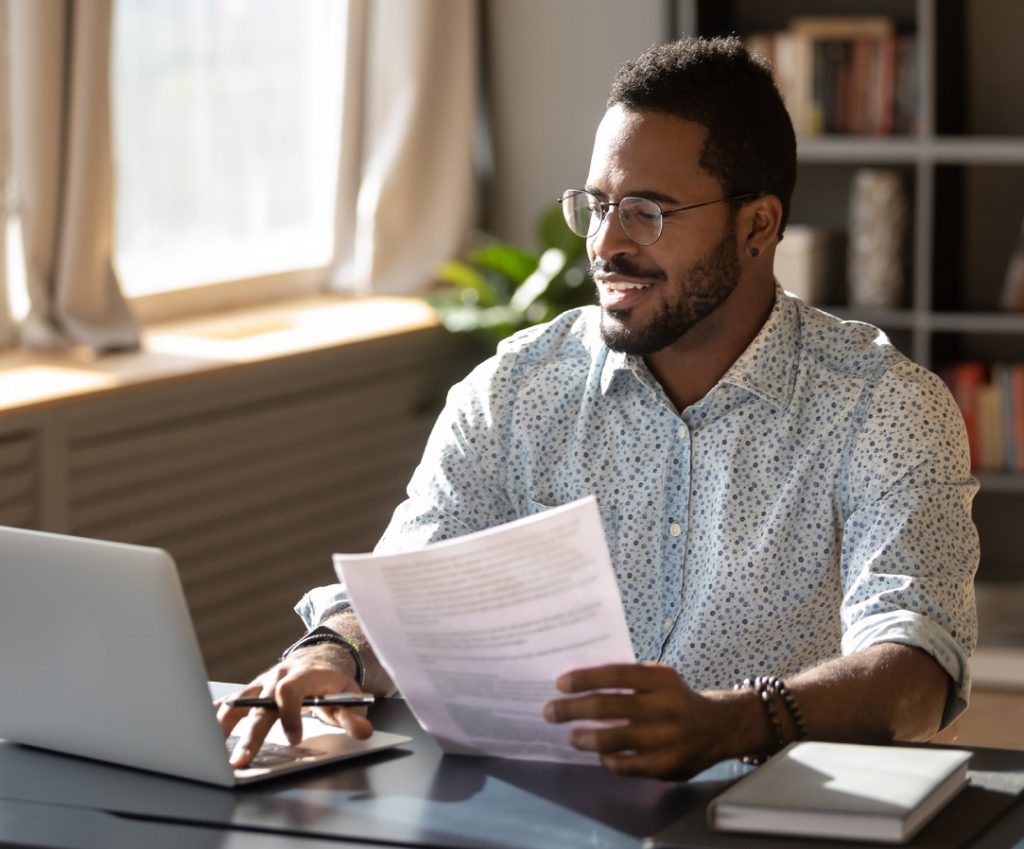 Happy man examining condo documents