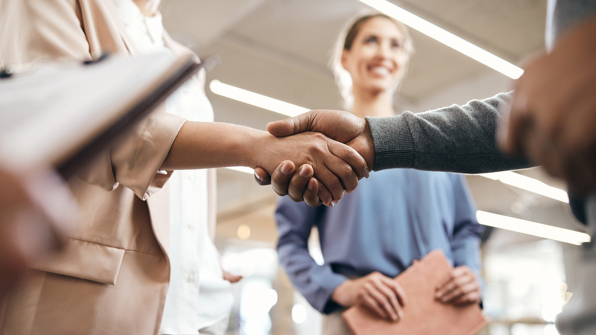 Two people shaking hands in a business partnership