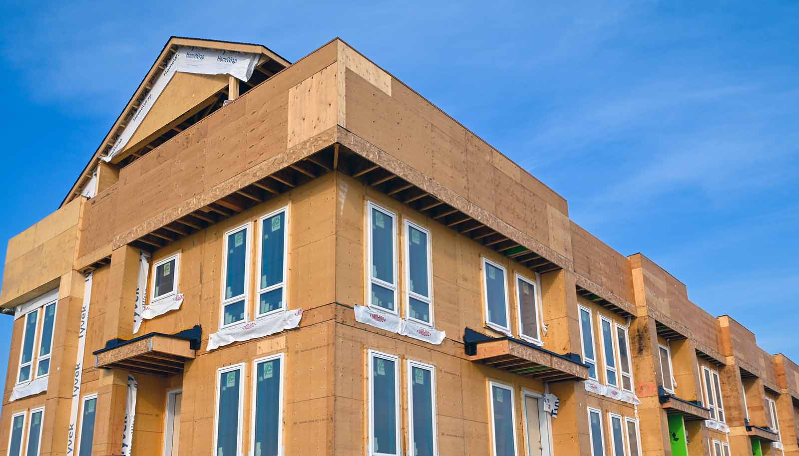 Under construction Avalon townhome building with a blue sky in the background