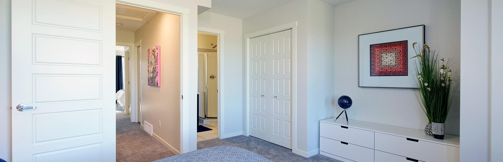Bright bedroom interior in Avalon Homes’ ZEN townhouse featuring built-in storage, modern decor, and neutral color palette.
